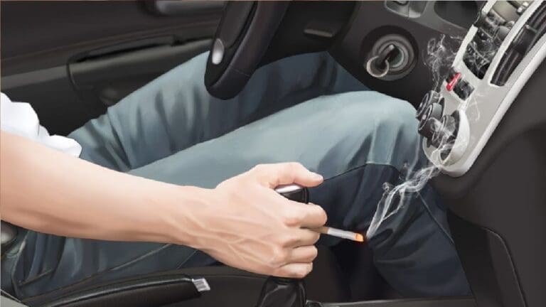 close shot of a hand on car gear with a cigarette in hand.