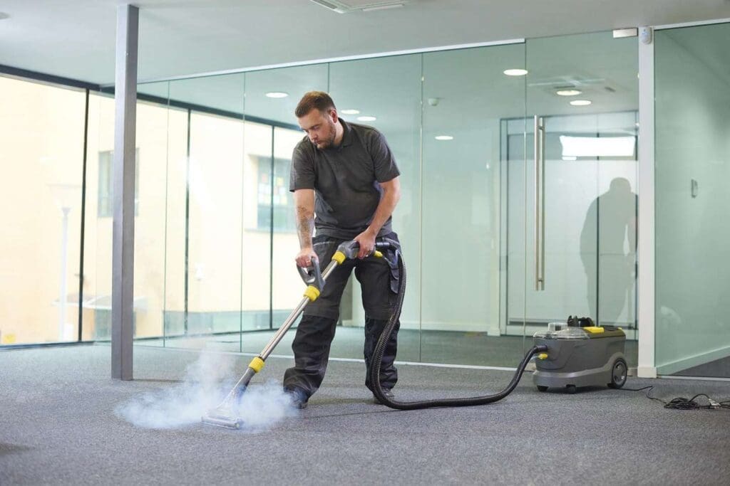 a professional cleaner steam cleaning carpet.